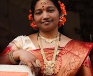 A beautiful Indian woman in a traditional sari, adorned with jewelry, captured during a local festival.